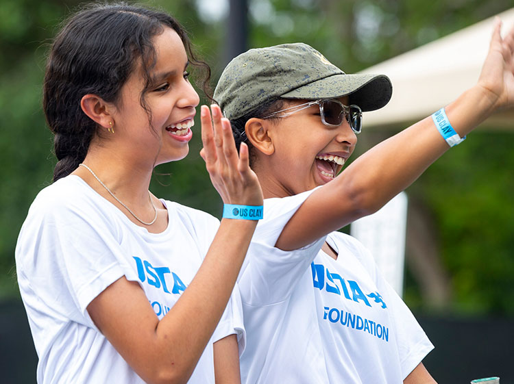 USTA Foundation young people waving