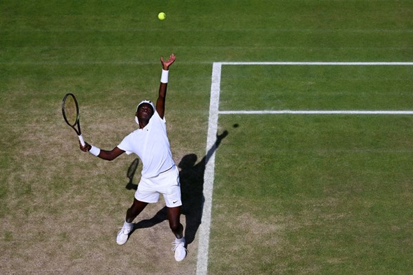 Carel Ngounoue serves against Matie Todoran of Romania during their boys' 14 and under singles semifinals.