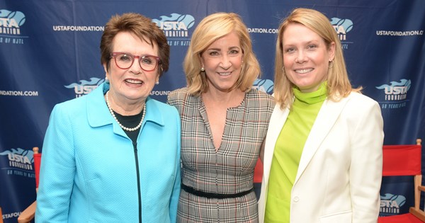 The ESPN's Chris McKendry with two other women posing in front of a USTA Foundation banner in support