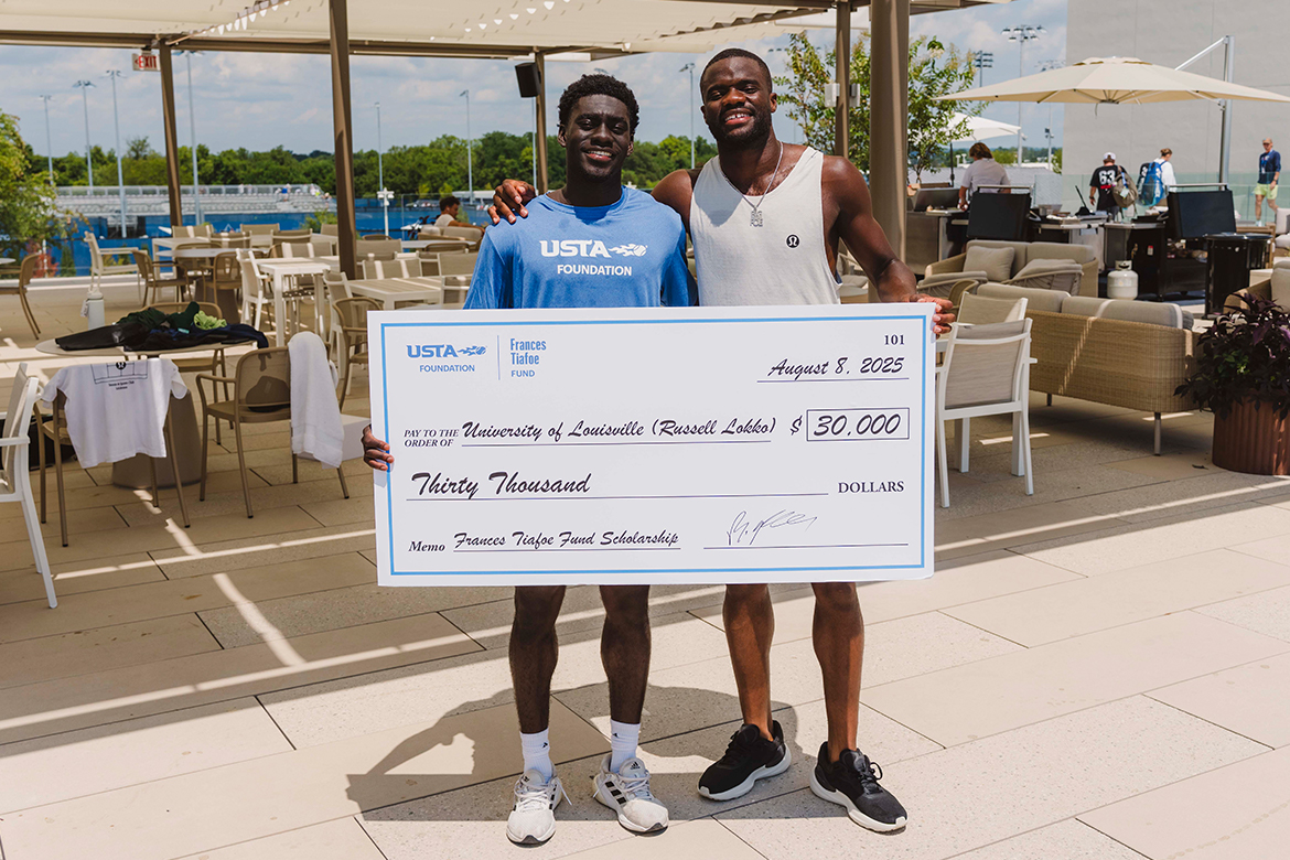 Frances Tiafoe and Russell Lokko hold a giant check.