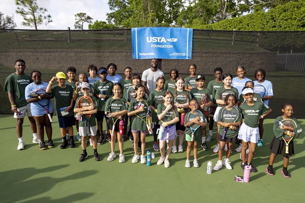 Youth from the Houston Tennis Association pose for a photo with Frances Tiafoe at a USTA Foundation clinic at the River Oaks Country Club in Houston, Texas.