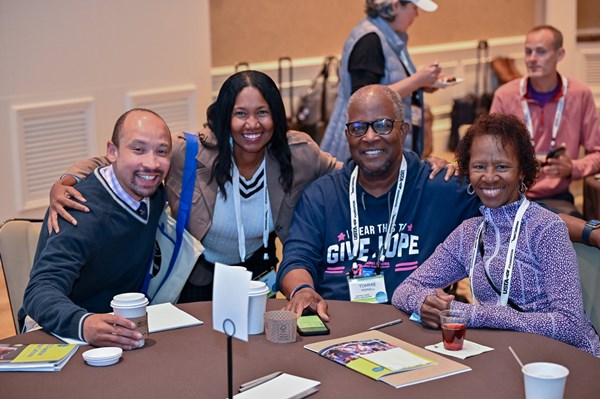 Leaders from the USTA Foundation’s National Junior Tennis and Learning network sitting at a table posing together