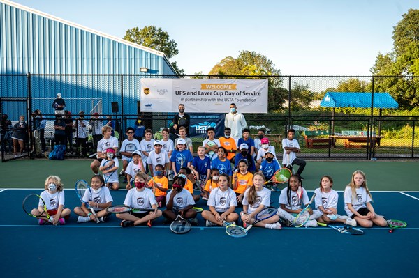 Kyrgios and Sock ahead of the 2021 Laver Cup on a tennis court with youth tennis players