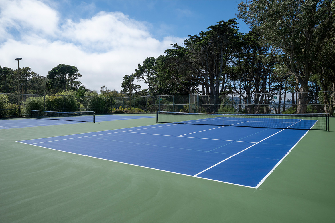Tennis courts in a park.