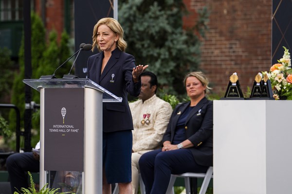 The ceremony of Home of Newport NJTL named in honor of Chris Evert with a woman at the podium speaking