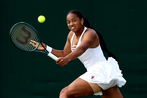 Robin Montgomery about to hit a tennis ball at Wimbledon, making her Wimbledon debut
