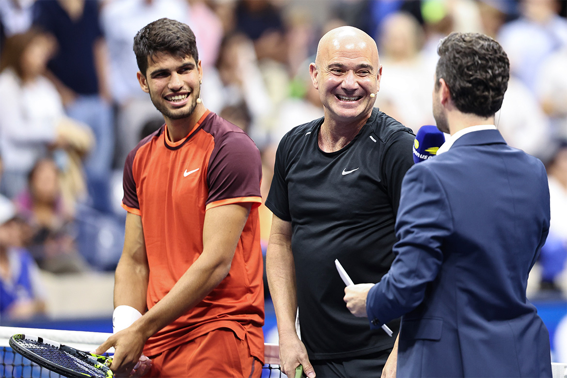 Two tennis players being interviewed on court.