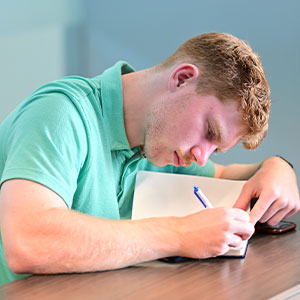 Student writing in a notebook