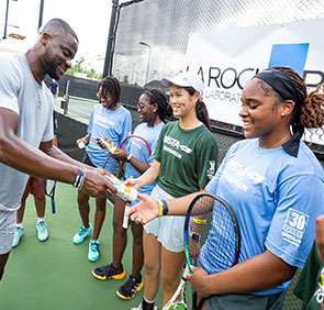 Frances Tiafoe giving students La Roche Posay.
